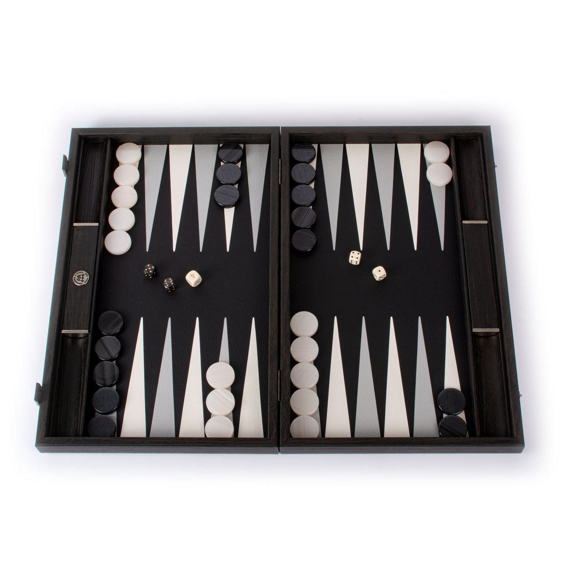 Open black leatherette backgammon set with white and black checkers and dice by MANOPOULOS Chess and Backgammon featuring elegant Greek craftsmanship