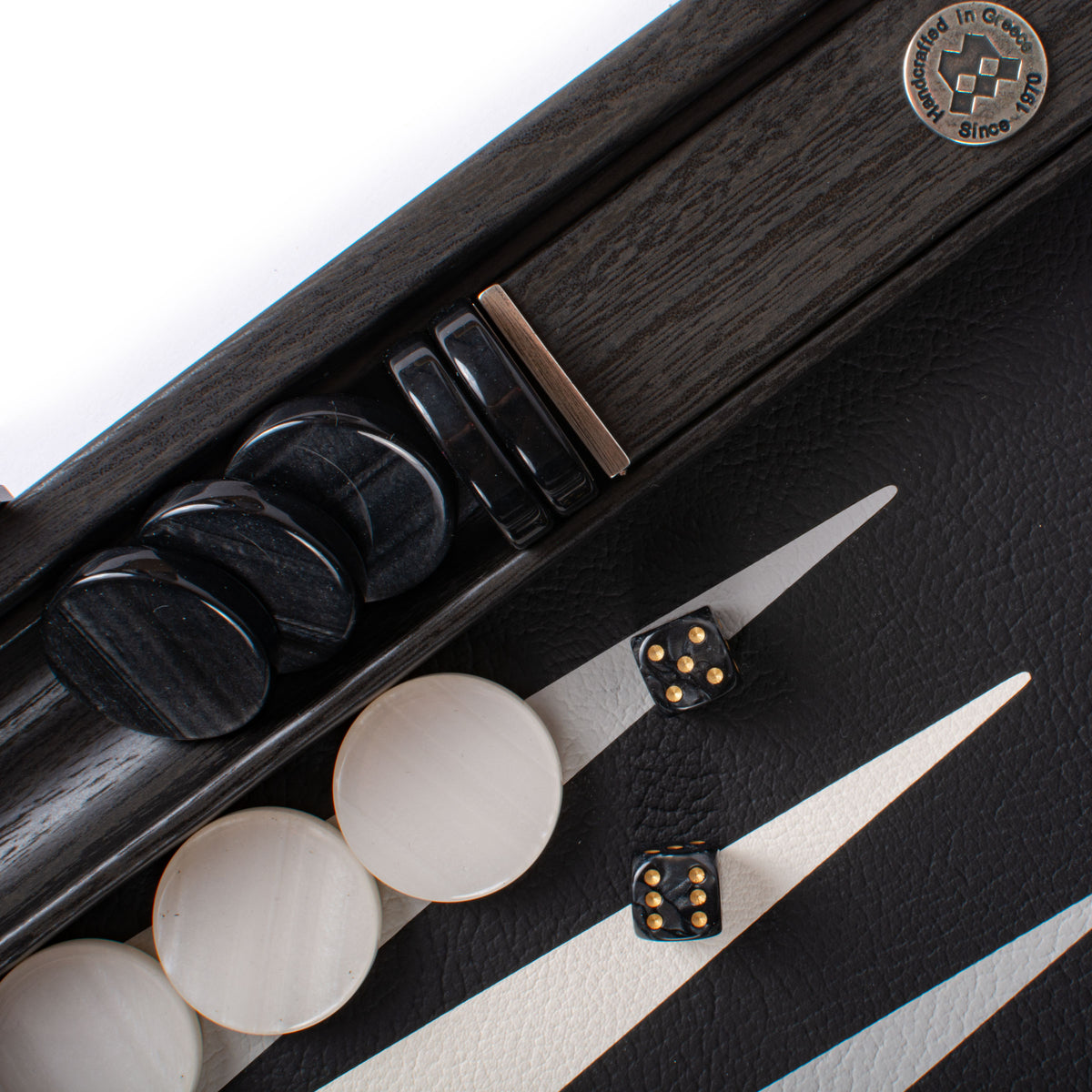 Premium black leatherette backgammon set with black and ivory checkers and dice in a refined board design by MANOPOULOS Chess and Backgammon
