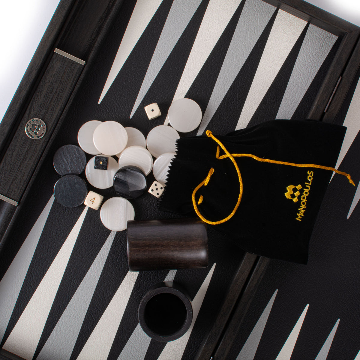 Black leatherette backgammon board with striped playing surface white and black pieces dice cup and drawstring pouch by MANOPOULOS Chess and Backgammon