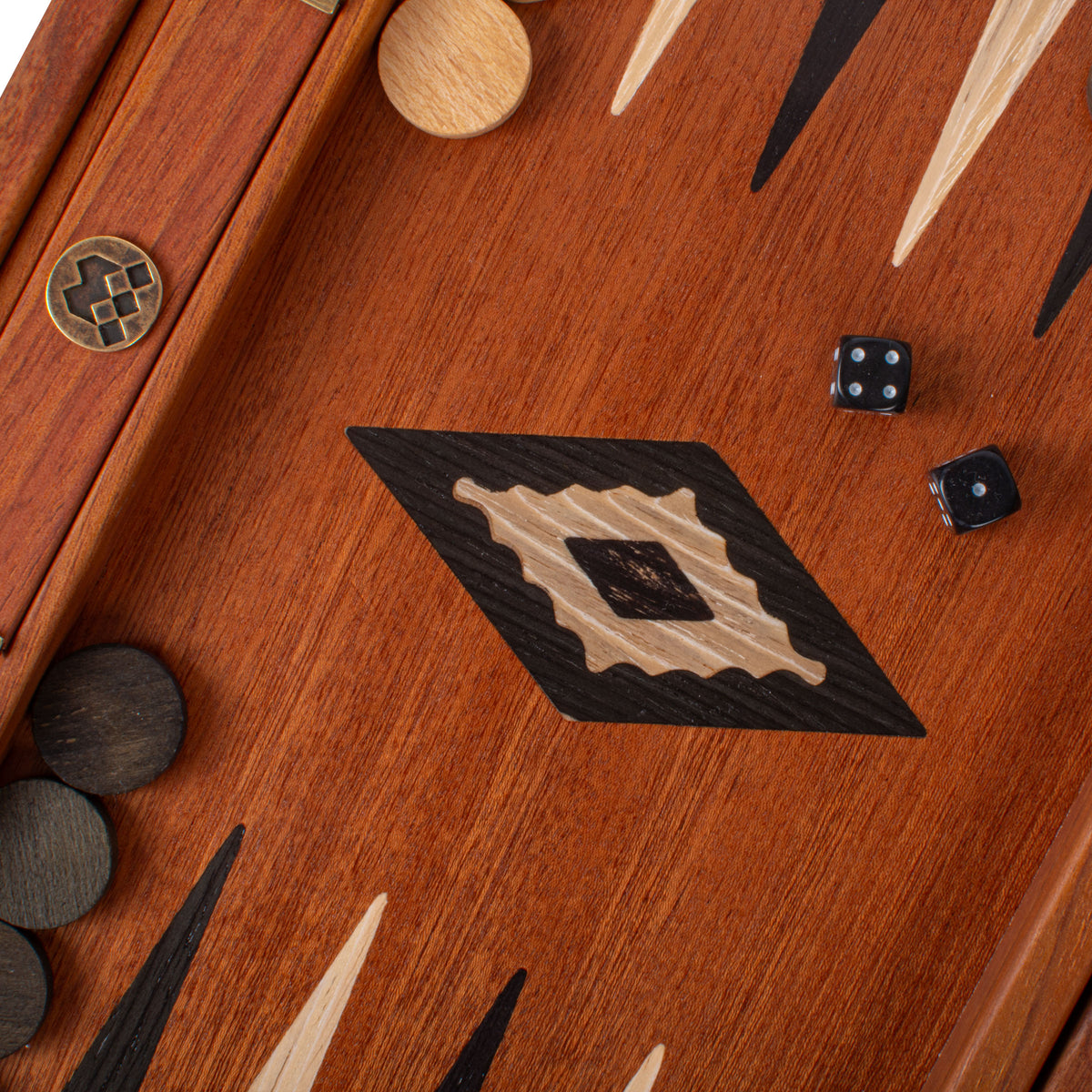 Close view of a handcrafted mahogany backgammon board with elegant marquetry inlay black and ivory playing points dice and wooden checkers by Manopoulos Chess and Backgammon