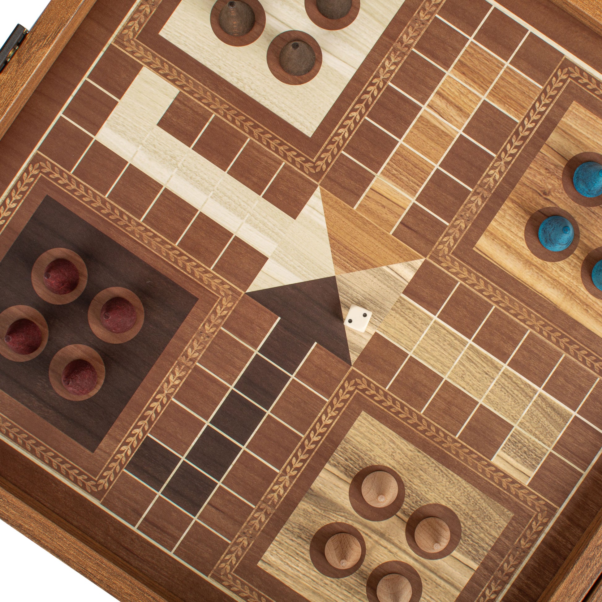 Close-up of a handcrafted wooden game board featuring detailed inlay work and game pieces arranged for Ludo and other classic games, part of the Classic Style 4-in-1 Combo Game Set: Chess, Backgammon, Ludo & Snakes by MANOPOULOS Chess & Backgammon, showcasing Greek craftsmanship, artisan-made quality, and luxury board games with timeless design.