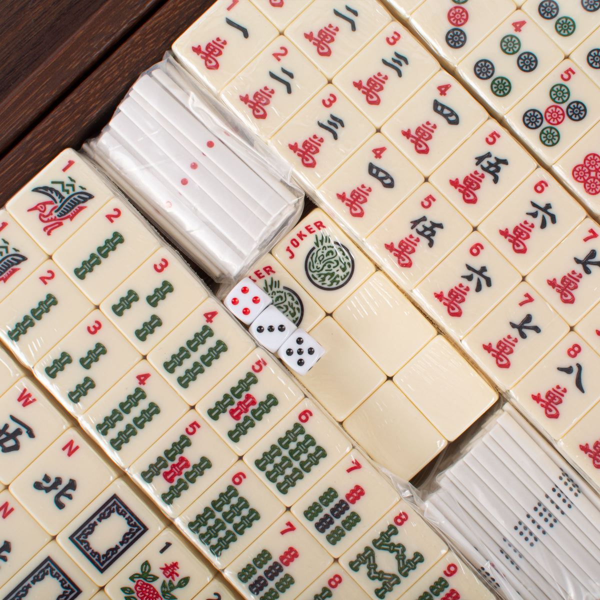 Premium mahjong tiles with colorful traditional symbols and dice arranged in a dark wooden case by MANOPOULOS Chess and Backgammon