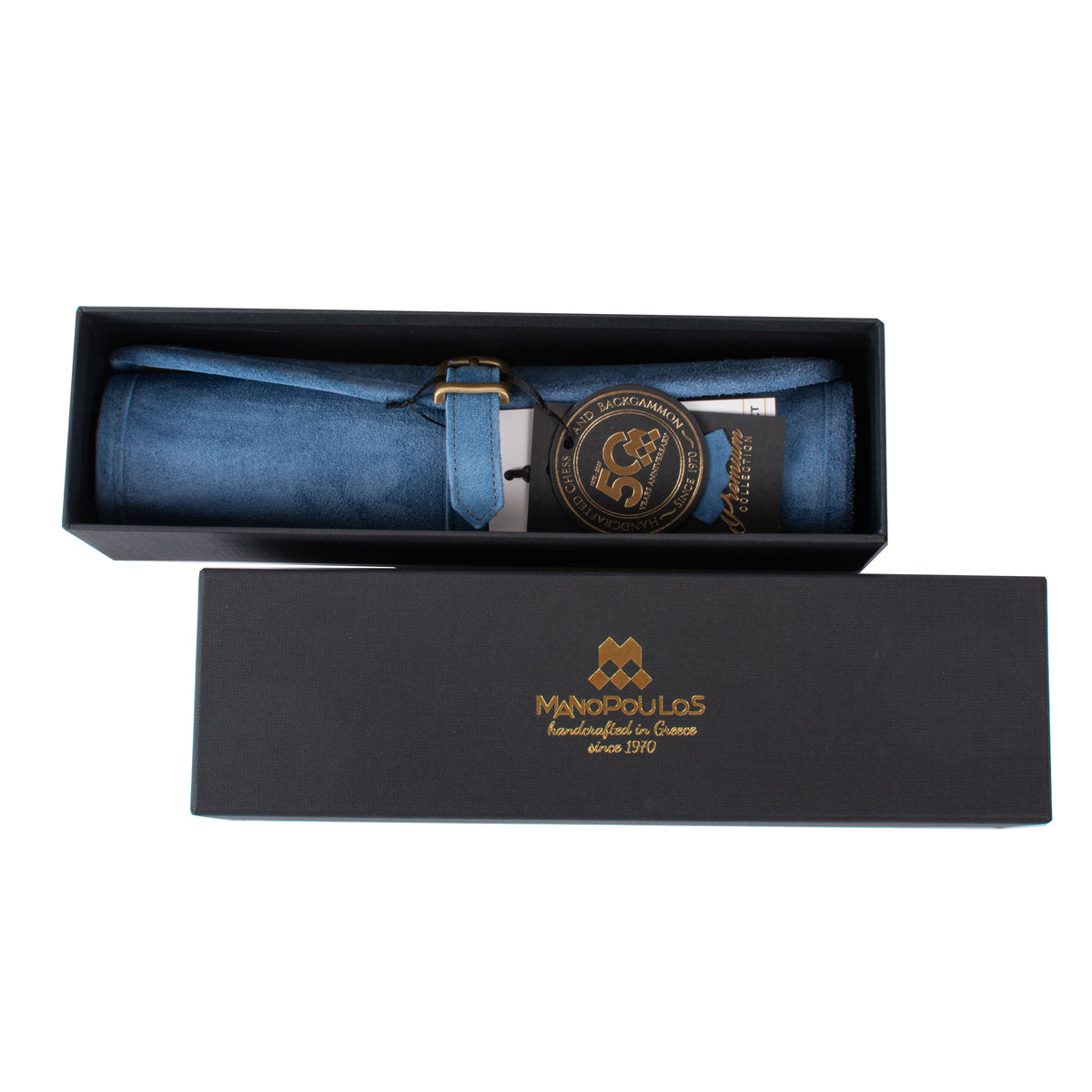 Blue suede roll up backgammon set in an open presentation box with Manopoulos branding showcasing Greek craftsmanship and luxury design by MANOPOULOS Chess & Backgammon