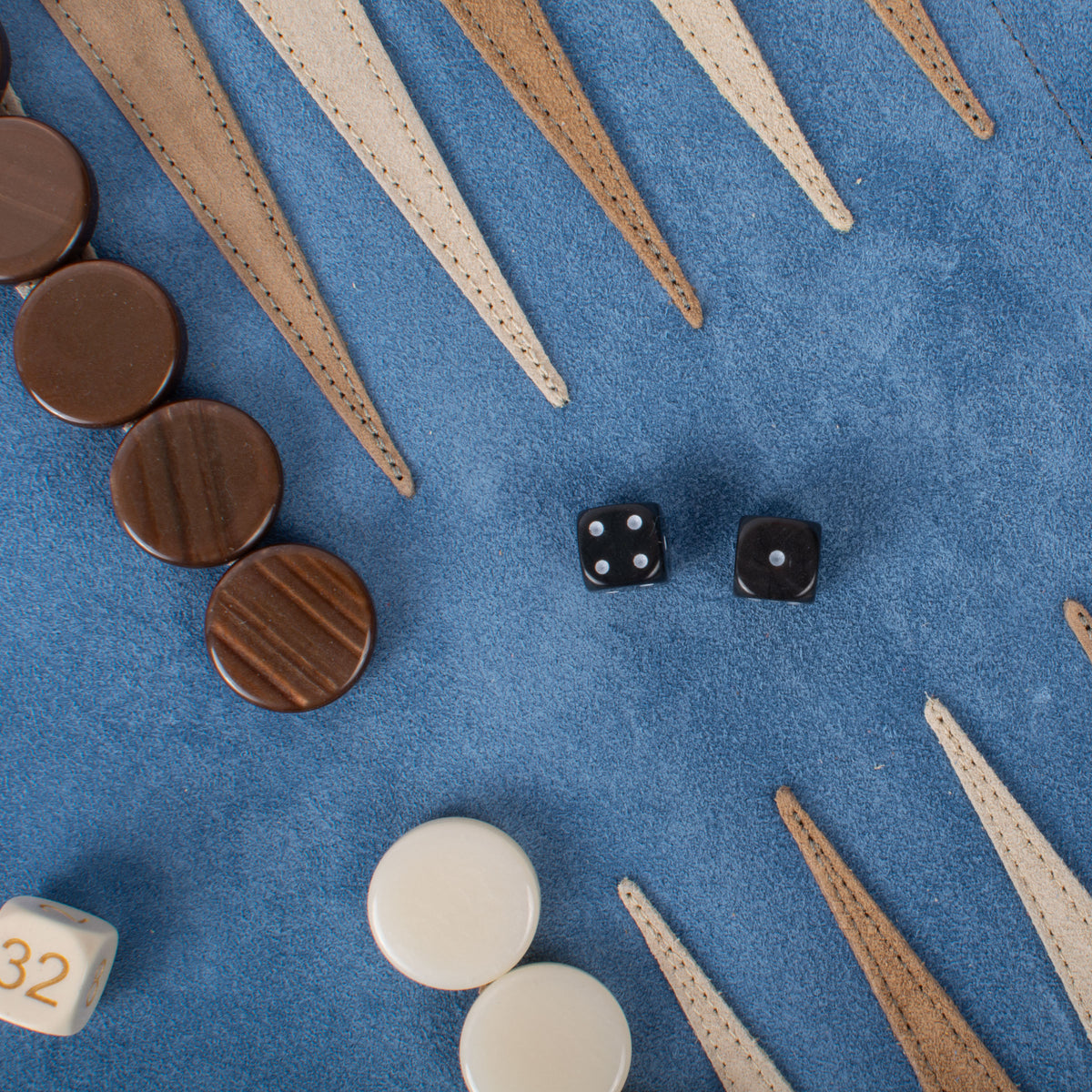 Manopoulos handcrafted blue suede backgammon set with stitched leather points wooden and ivory checkers and black dice showcasing Greek craftsmanship and luxury design