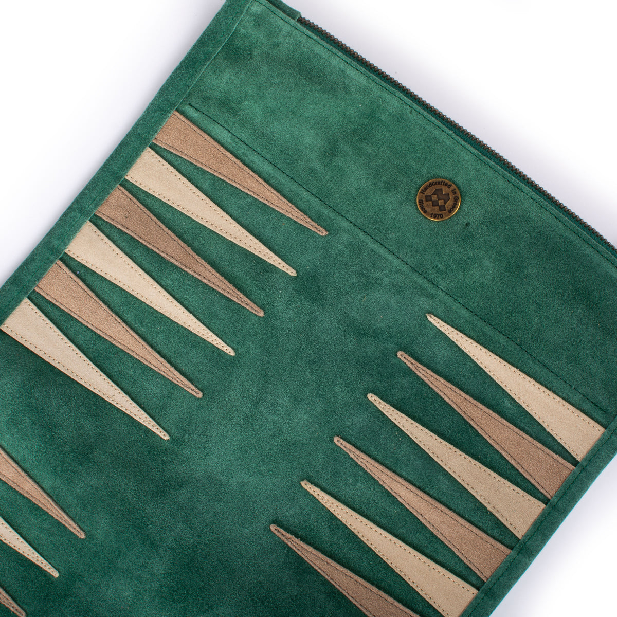 Forest green suede roll up backgammon board with elegant cream and tan points, showcasing Manopoulos handcrafted Greek craftsmanship and luxury game design