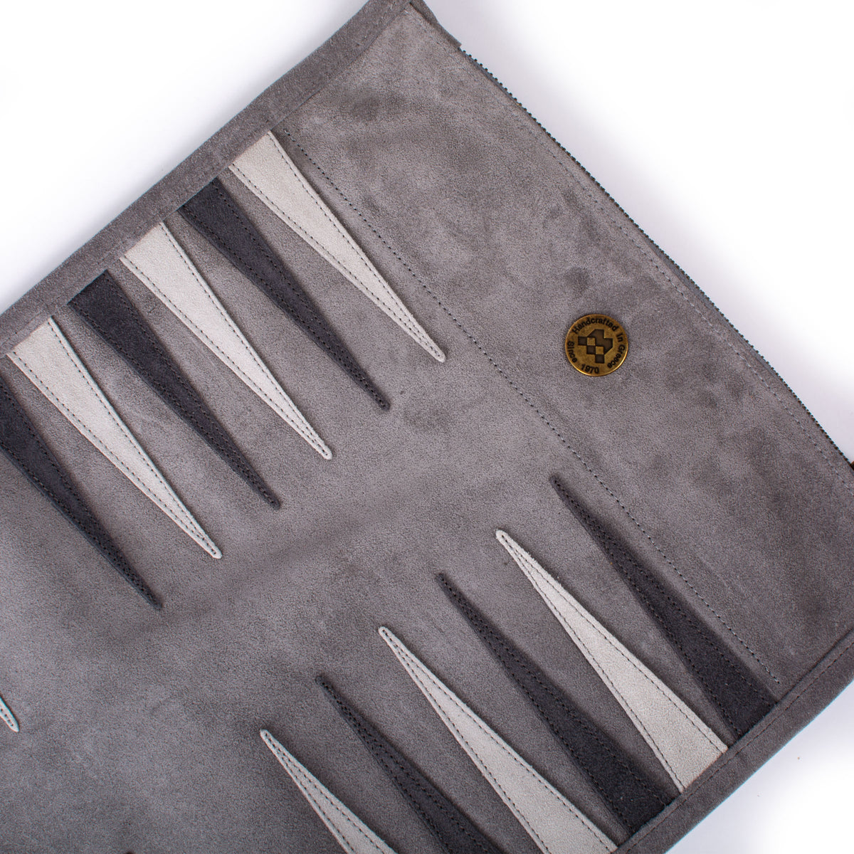 Grey suede roll up backgammon board with contrasting light and dark points and Manopoulos emblem showcasing refined Greek craftsmanship and luxury game design