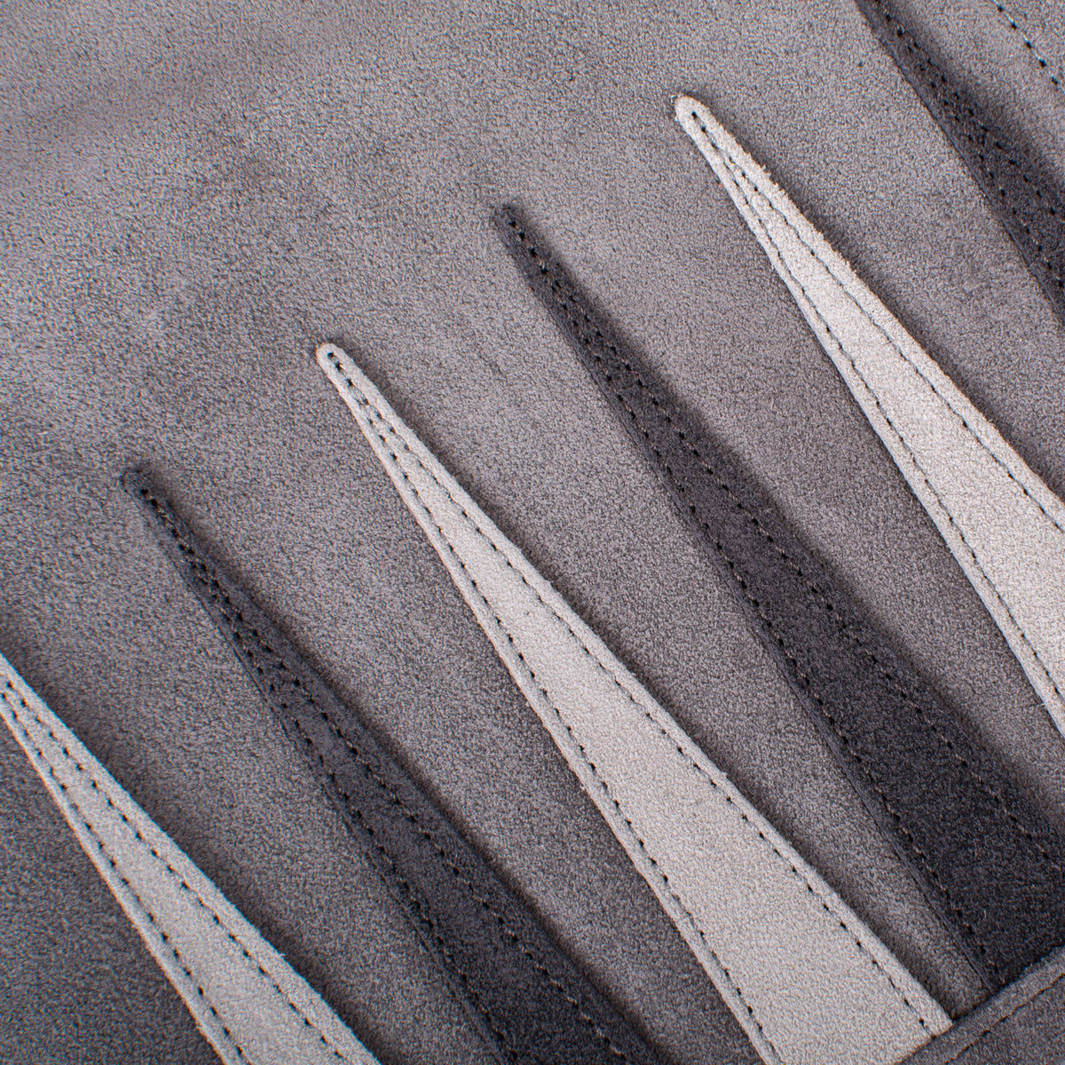 Close up of grey suede with contrasting stitched strips from a premium handcrafted backgammon set by MANOPOULOS Chess and Backgammon in Greece