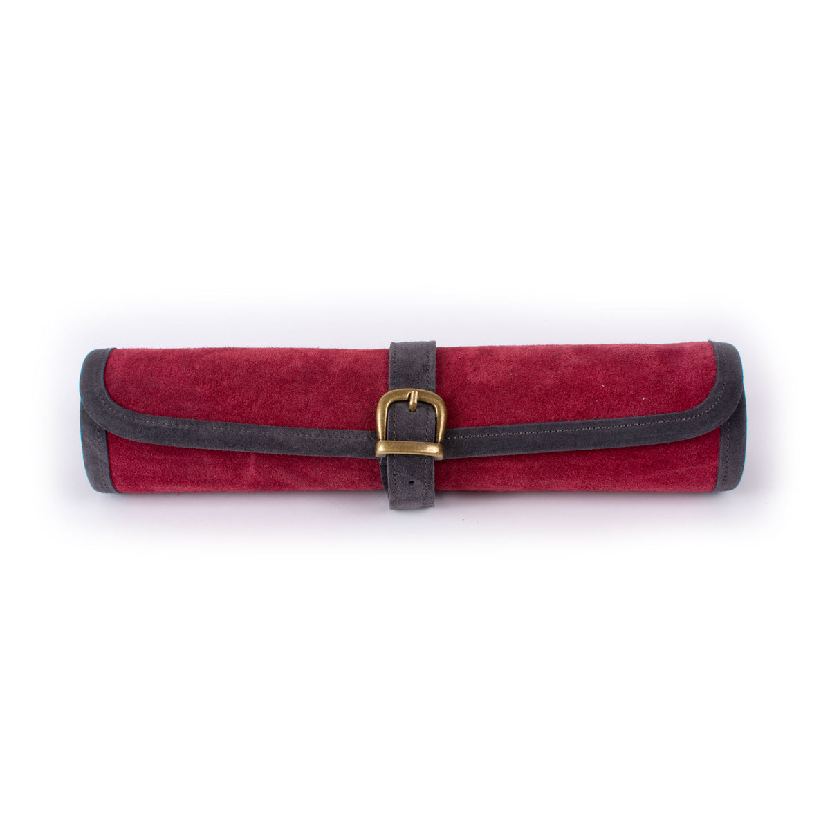 Red velvet roll up case with dark leather trim, a central strap, and brass buckle, shown against a plain white background