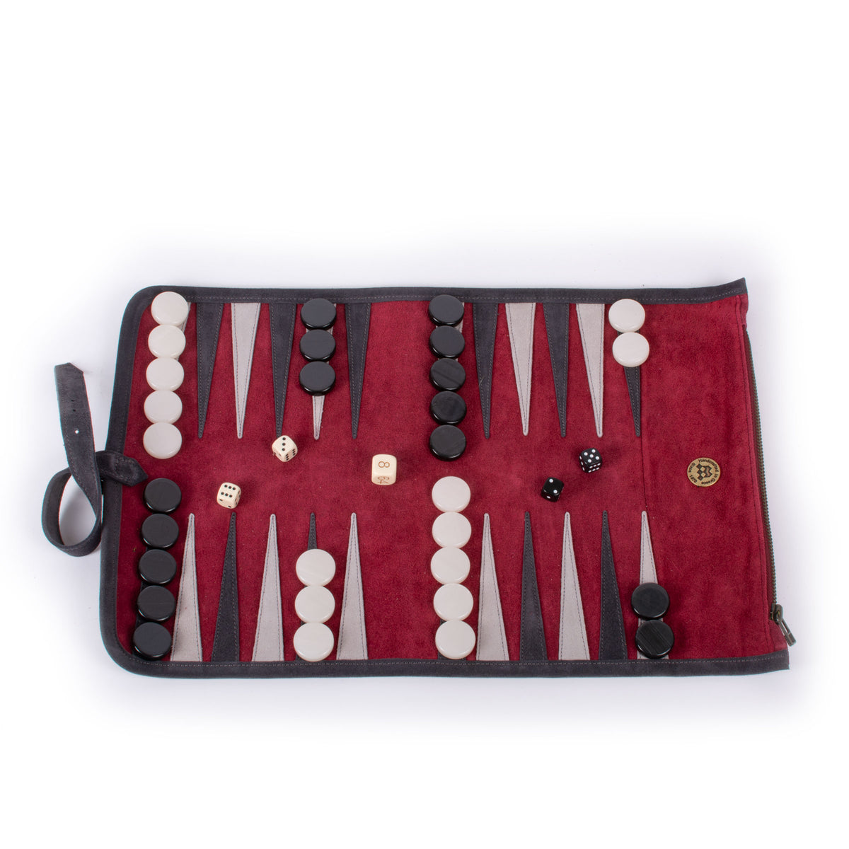 Open burgundy backgammon board with black and ivory checkers and dice arranged inside on a white background