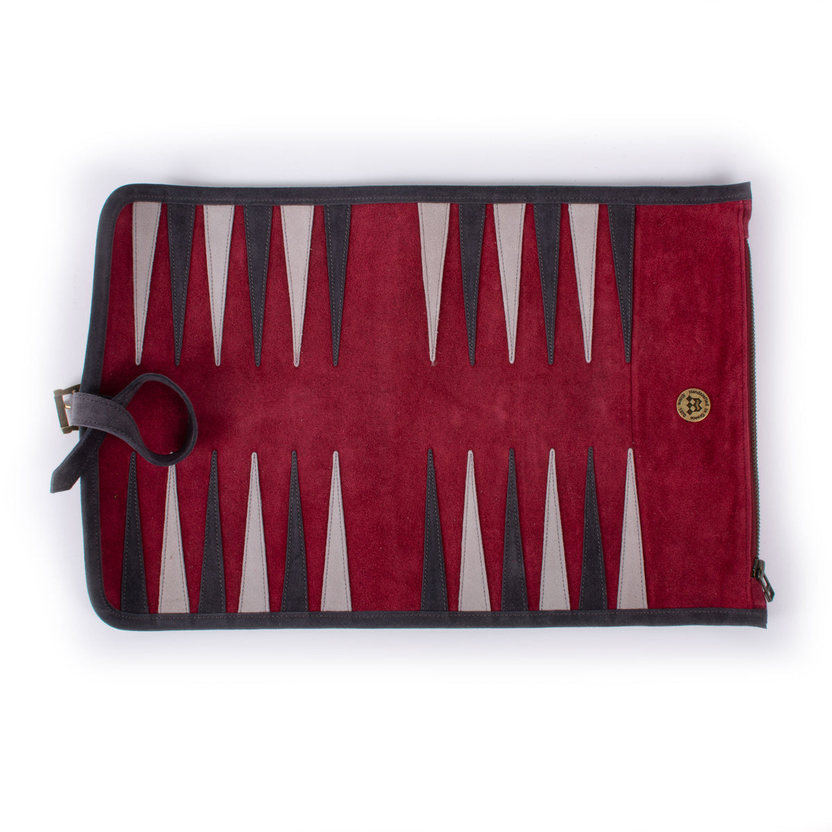 Red velvet backgammon board with burgundy, black, and cream triangular playing points, dark trim, side strap, and a small round emblem.