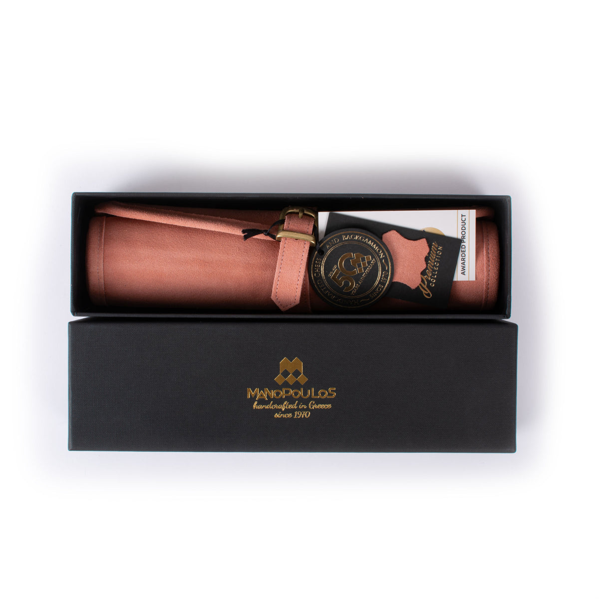 Premium salmon suede roll up backgammon set in a black presentation box with MANOPOULOS branding, showcasing Greek craftsmanship and luxury design