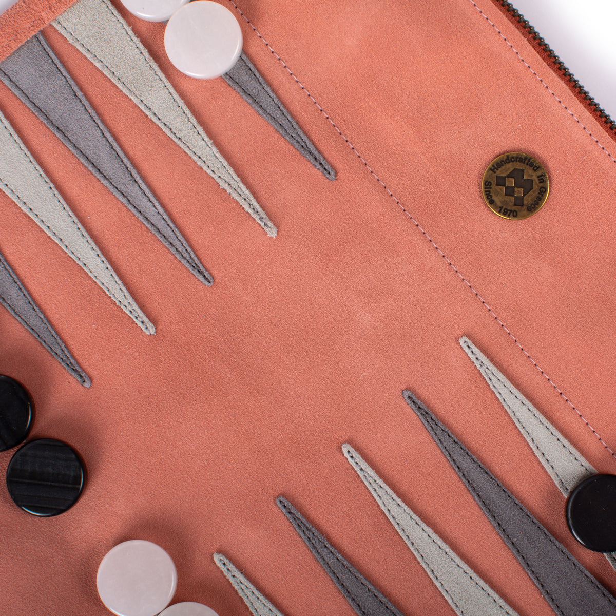 Salmon suede backgammon board with stitched playing points and contrasting counters showcasing Greek craftsmanship by MANOPOULOS Chess and Backgammon