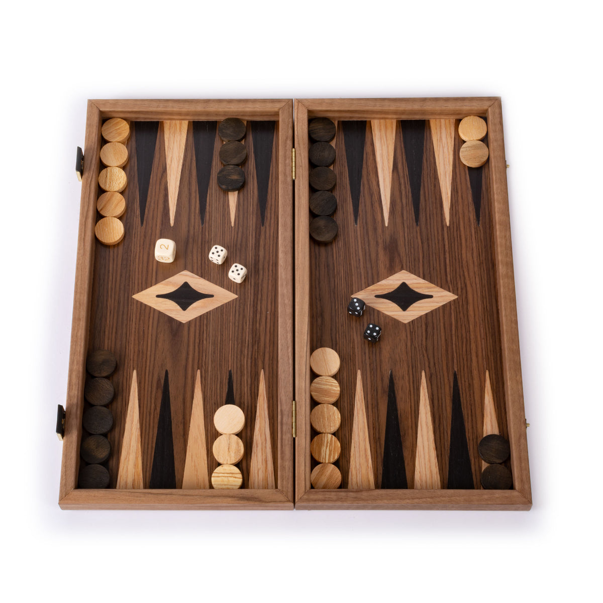 Open wooden backgammon board with contrasting dark and light playing pieces and dice arranged across the pointed playing triangles on a white background