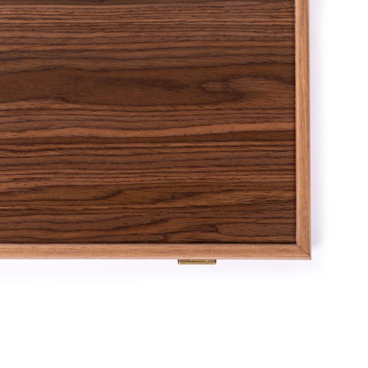 Close-up of a dark wood grain board with a lighter wooden frame and small brass latch against a white background