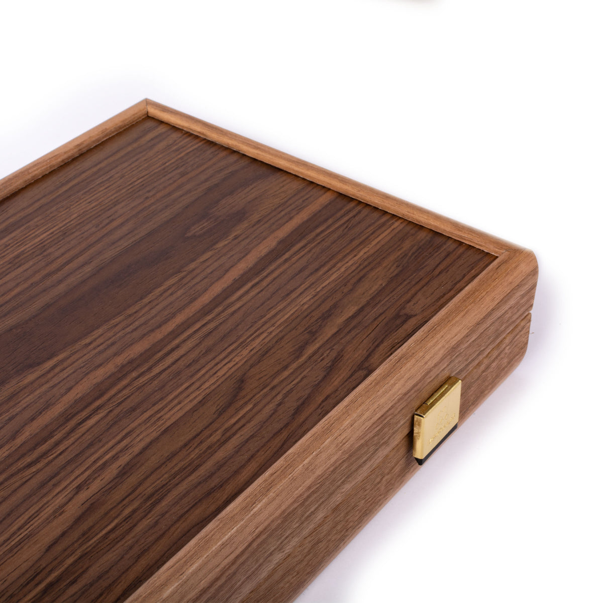 Close view of a dark wooden board corner showing natural wood grain, raised border, rounded edge, and a brass clasp on a white background