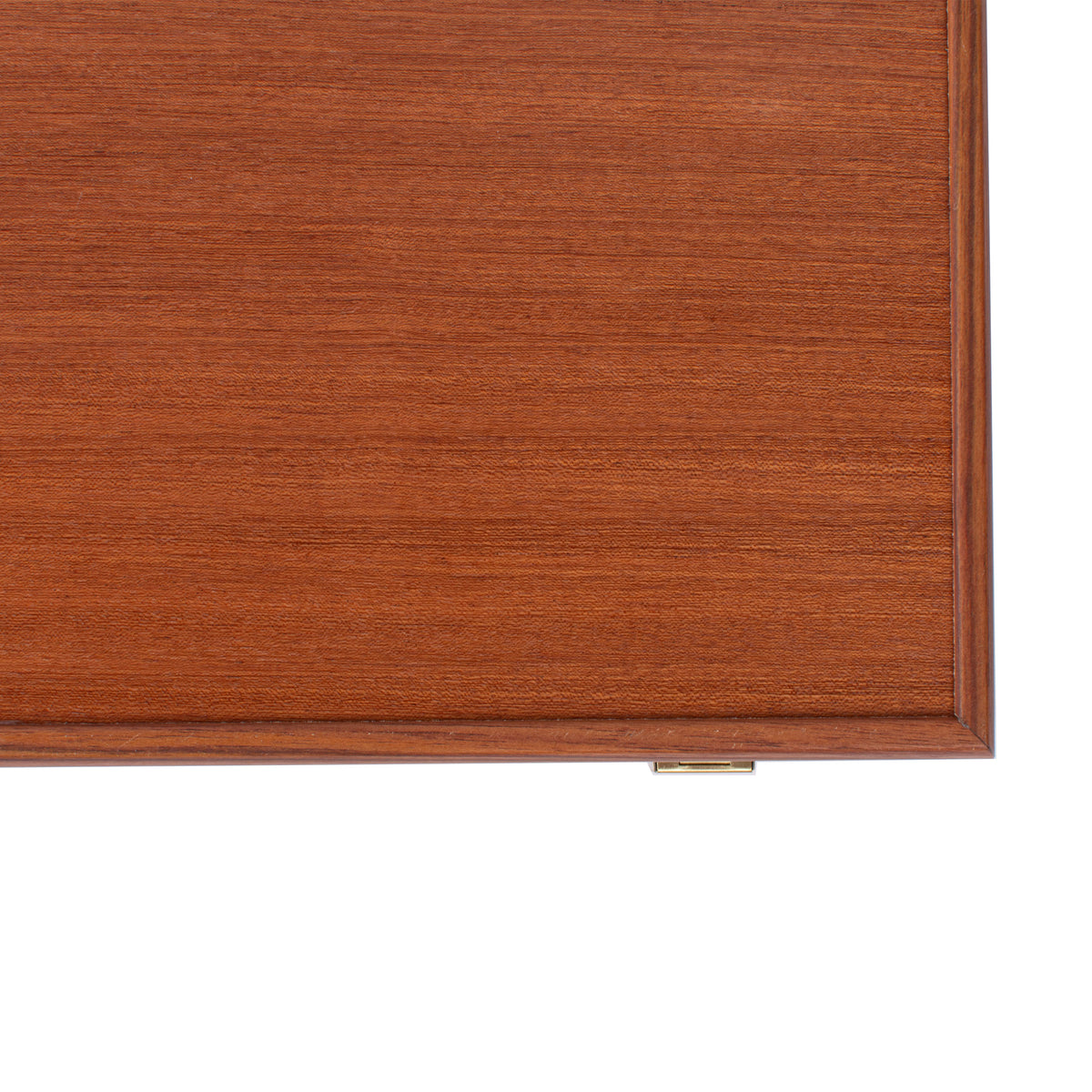 Close up of a handcrafted mahogany backgammon case with rich wood grain polished edges and a brass clasp by MANOPOULOS Chess and Backgammon