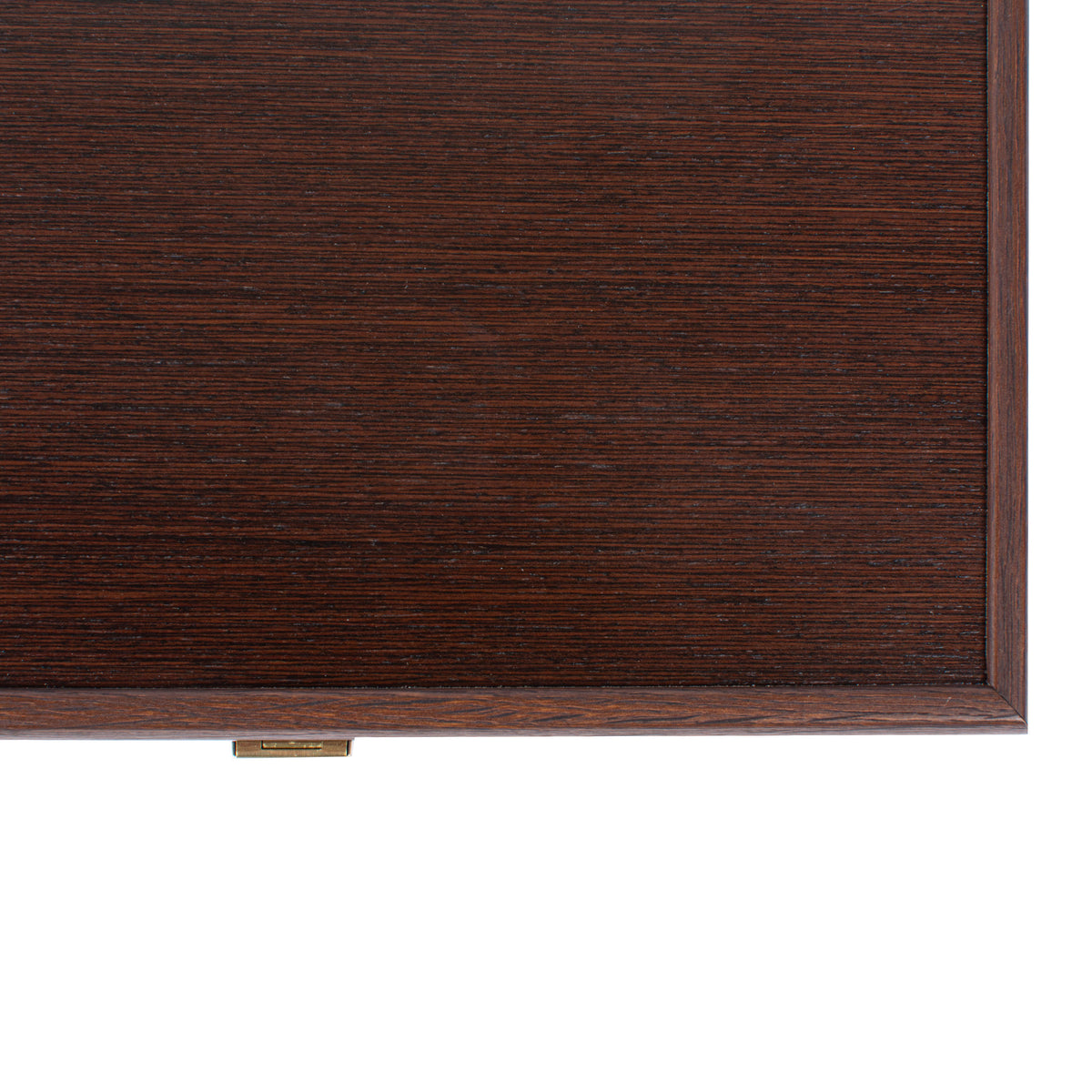 Close up of a dark wenge wood backgammon case with rich horizontal grain framed edges and a small brass clasp by MANOPOULOS Chess and Backgammon