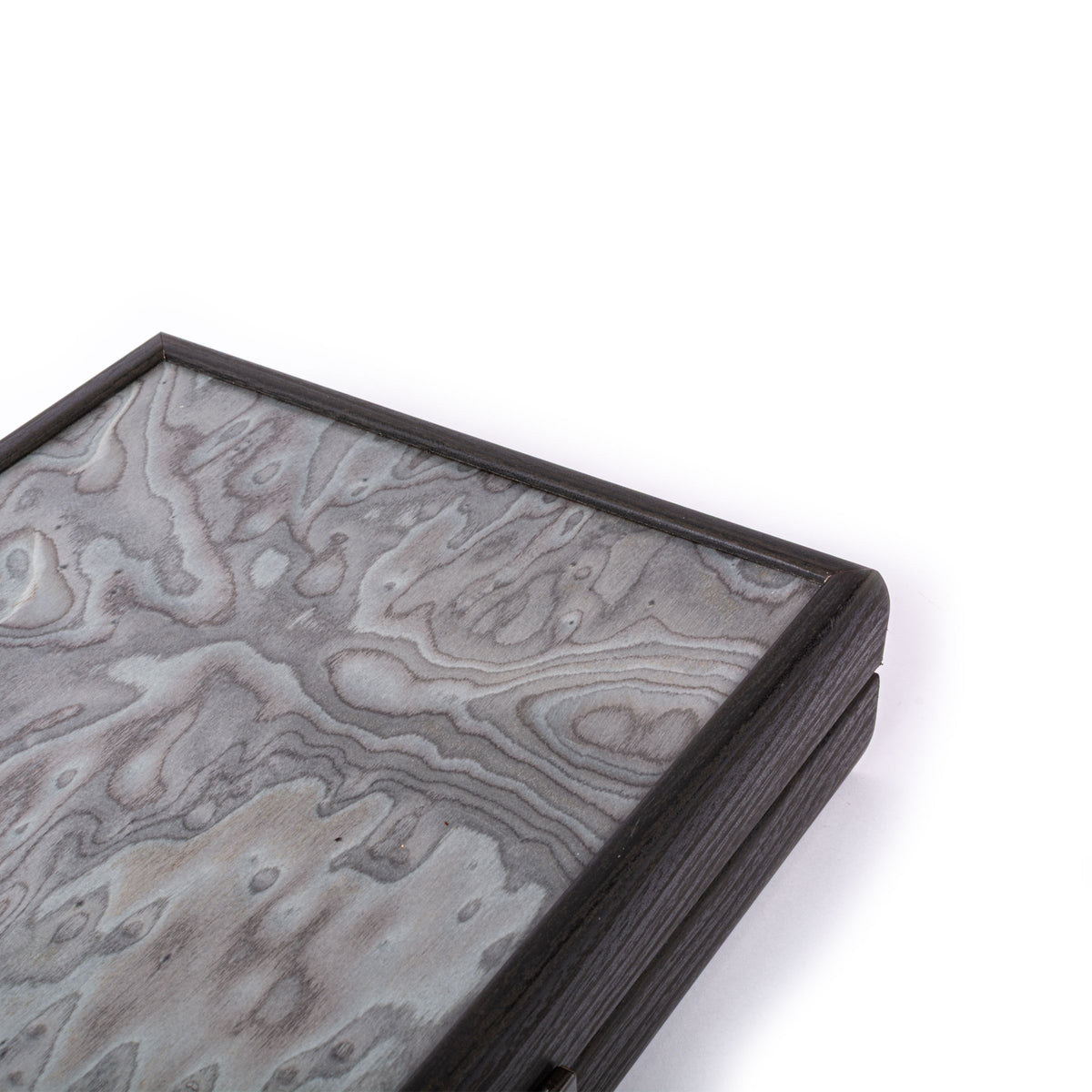 Close view of a handcrafted pearly grey vavona burl backgammon board with rich natural grain and dark wood edging by Manopoulos